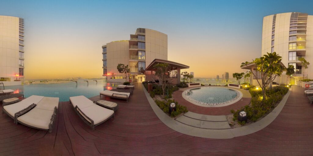 A preview of 360 degrees scanning for VR experience showing a rooftop infinity pool at sunset. Modern buildings surround the area.