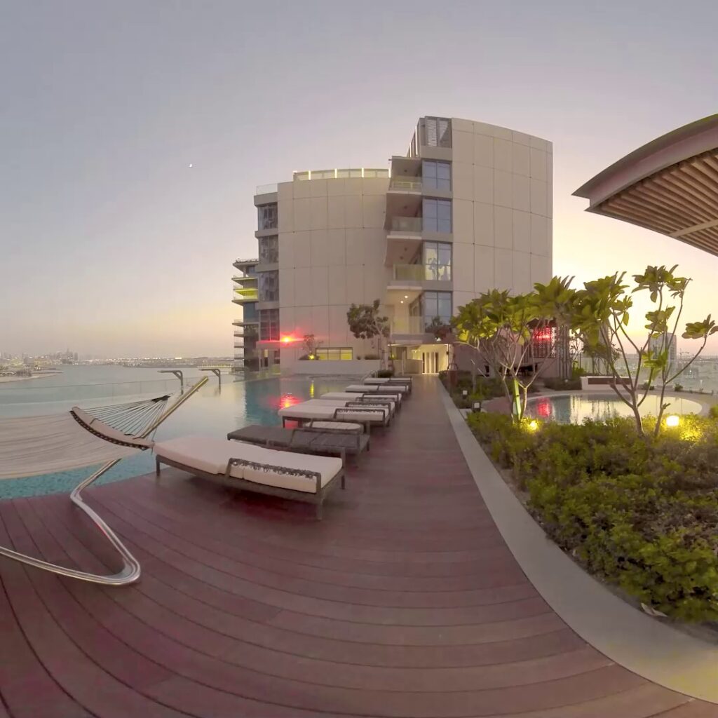 A preview of 360 degrees scanning for VR experience showing a rooftop infinity pool at sunset. Modern buildings surround the area.