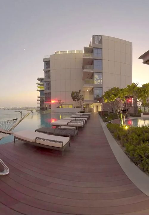 A preview of 360 degrees scanning for VR experience showing a rooftop infinity pool at sunset. Modern buildings surround the area.