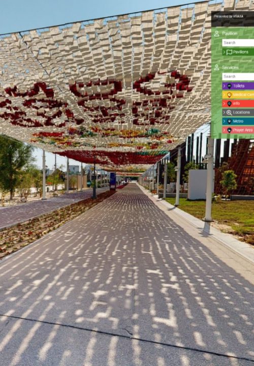 A preview of virtual experience showing a shaded pathway with colorful knitted canopy overhead in a park setting. A path runs through, flanked by plants and trees. A side menu showing some services available in the area.